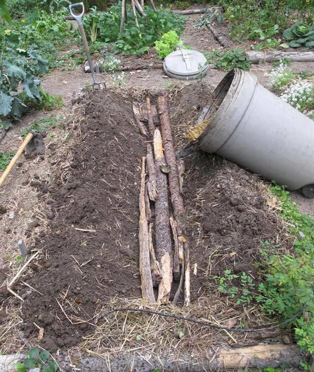 trench in garden and garbage can compost